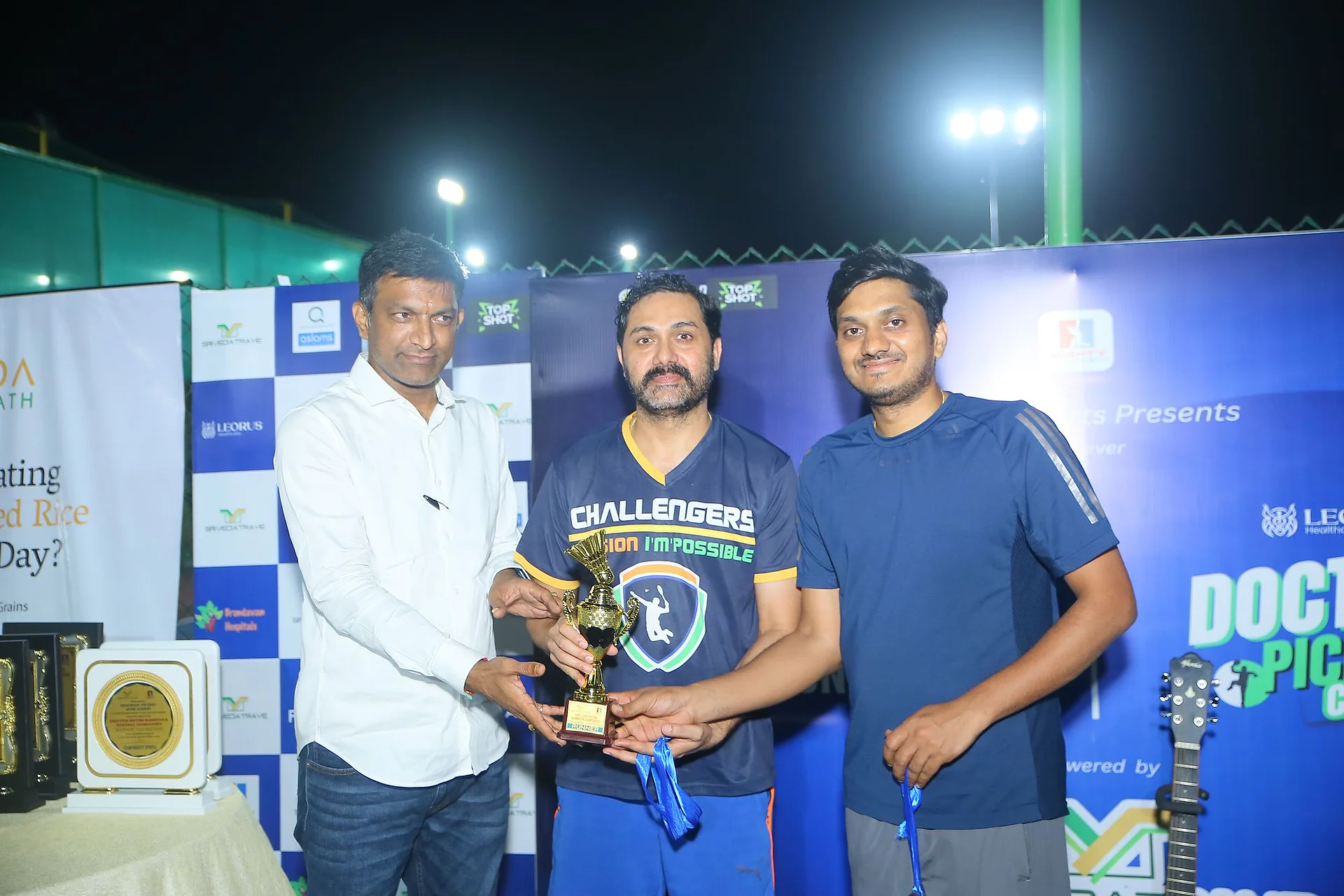 Runners-up receiving a trophy at the Doctors Badminton Championship