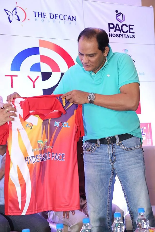 A guest holding up a team jersey at a Doctors Cricket League event