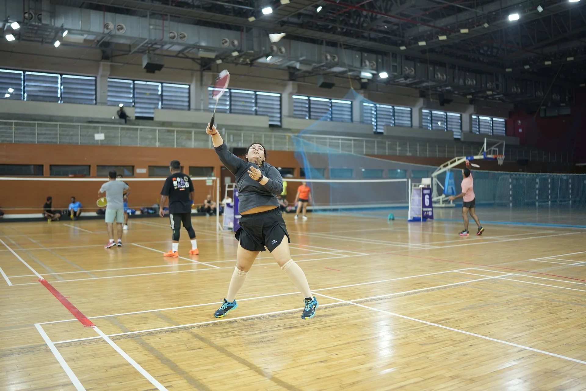 A player leaping for an overhead smash during a match in Goa